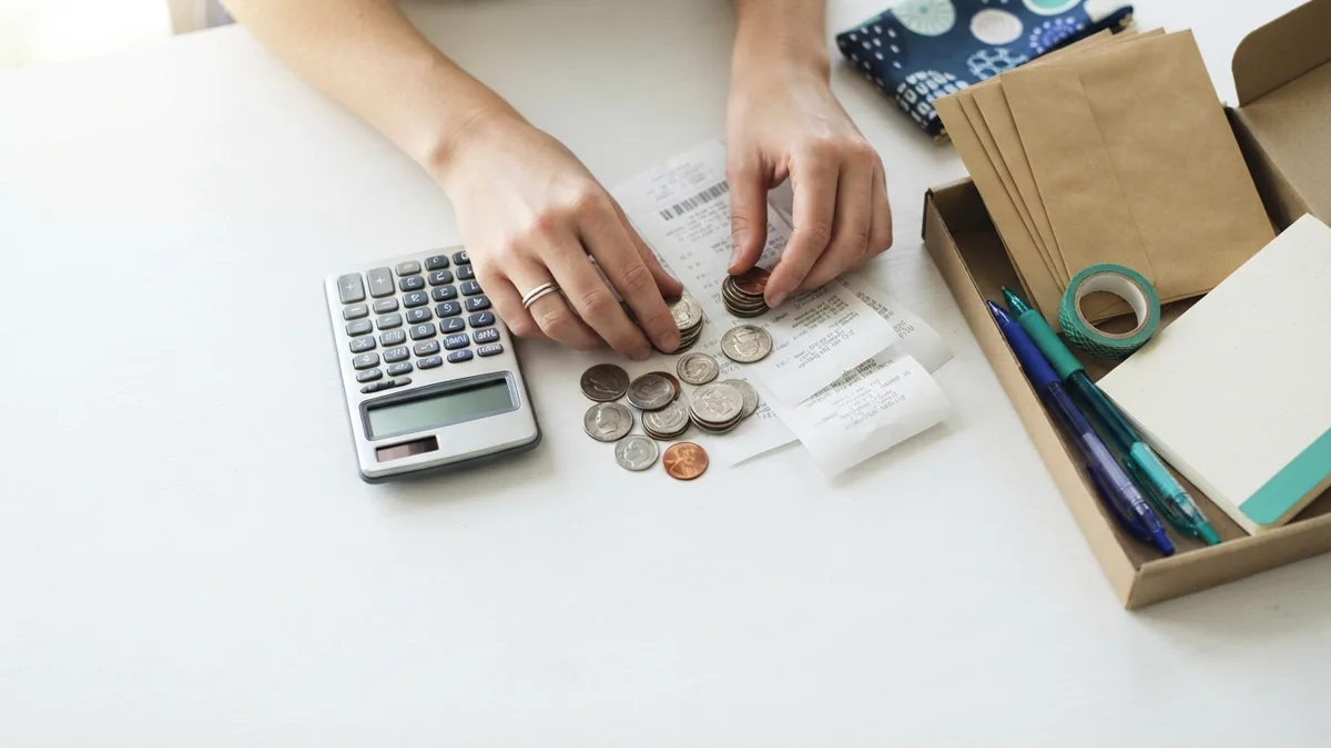 Working out startup funding Small business owner weighing startup costs and funding needs